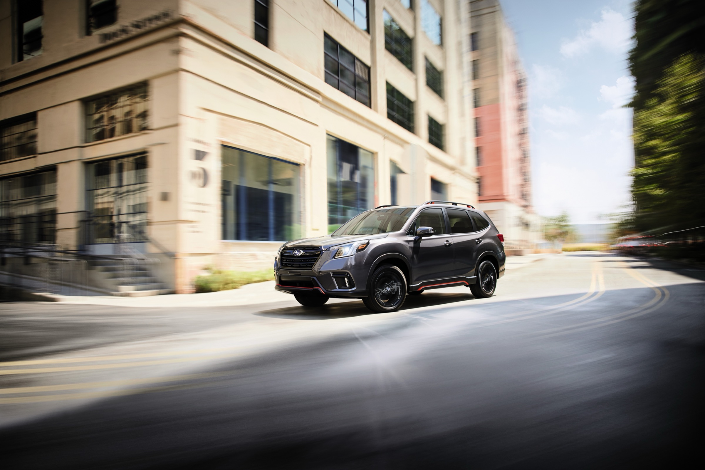 A recent-model-year Subaru Forester driving through a city street corner, shown to illustrate the Forester body style sold at Dalton Subaru National City