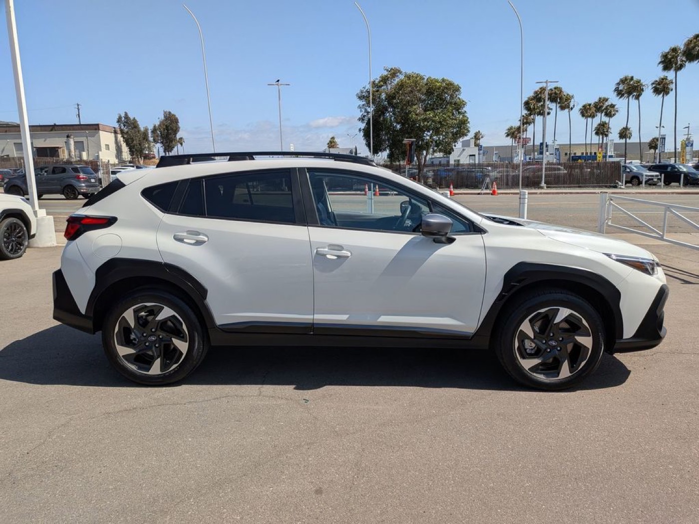 A white Subaru Crosstrek photographed in profile on the lot at Dalton Subaru on the National City Mile of Cars