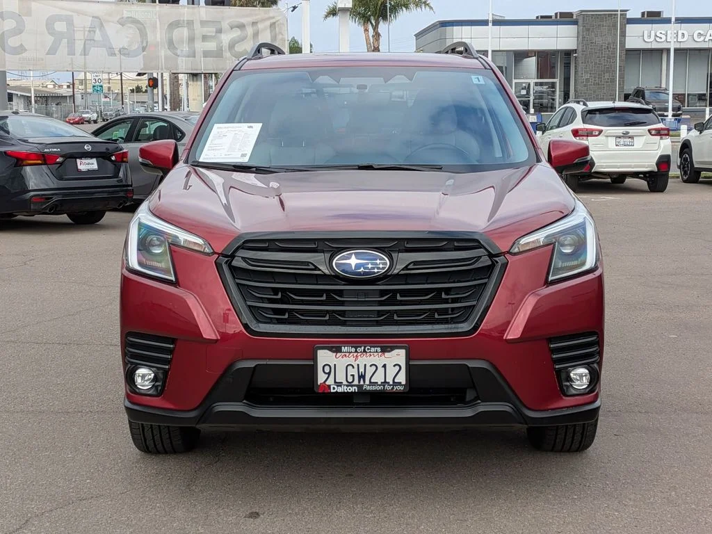 A red Subaru Forester on the used-car lot at Dalton Subaru National City, with the inspection paperwork still in the windshield